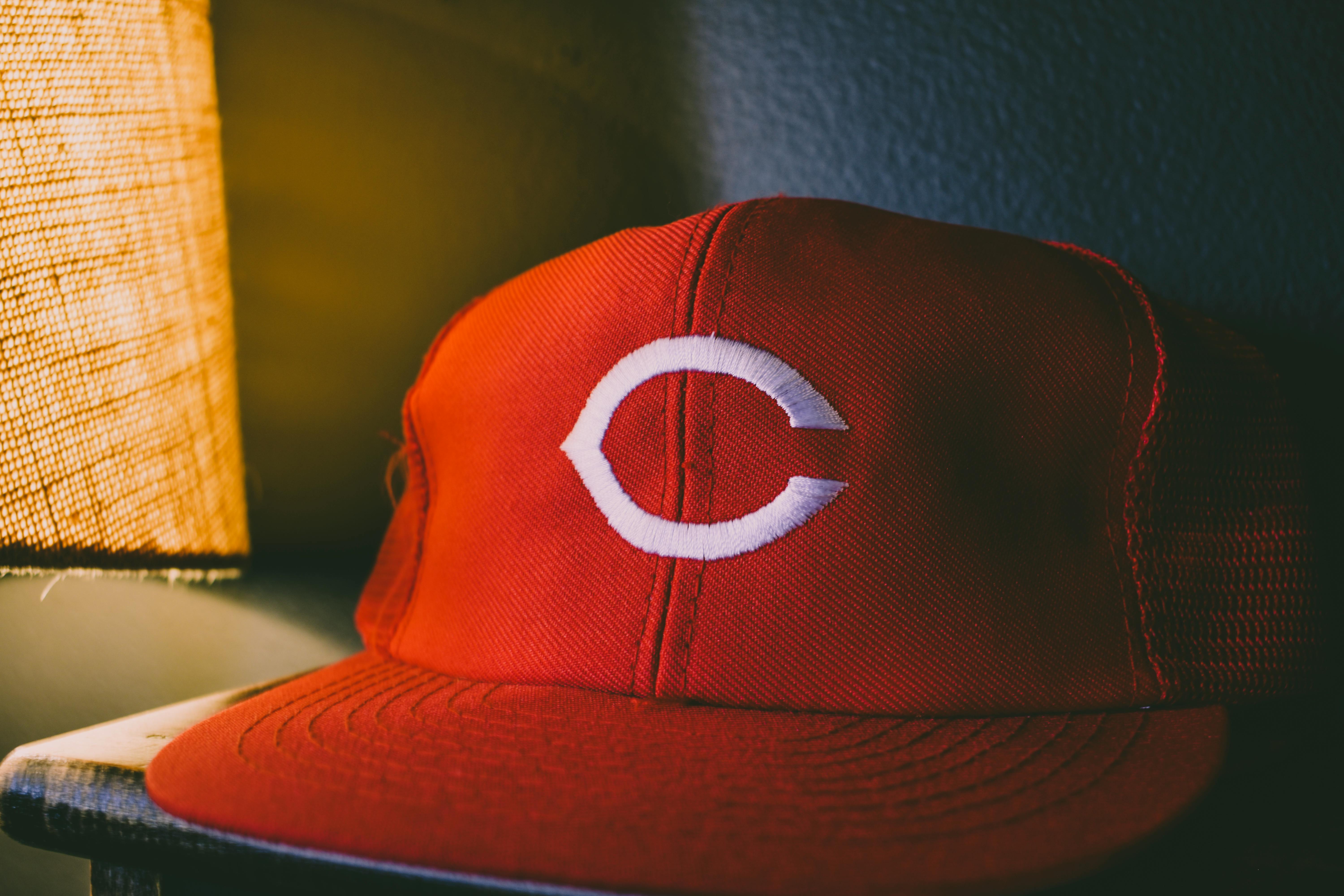 CloseUp Photo of a Red Cap Near a Lamp · Free Stock Photo