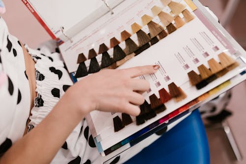 A Client Looking at a Hair Color Chart