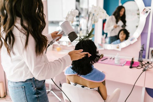 Free A Person Getting a Blow Dry at a Hair Salon Stock Photo