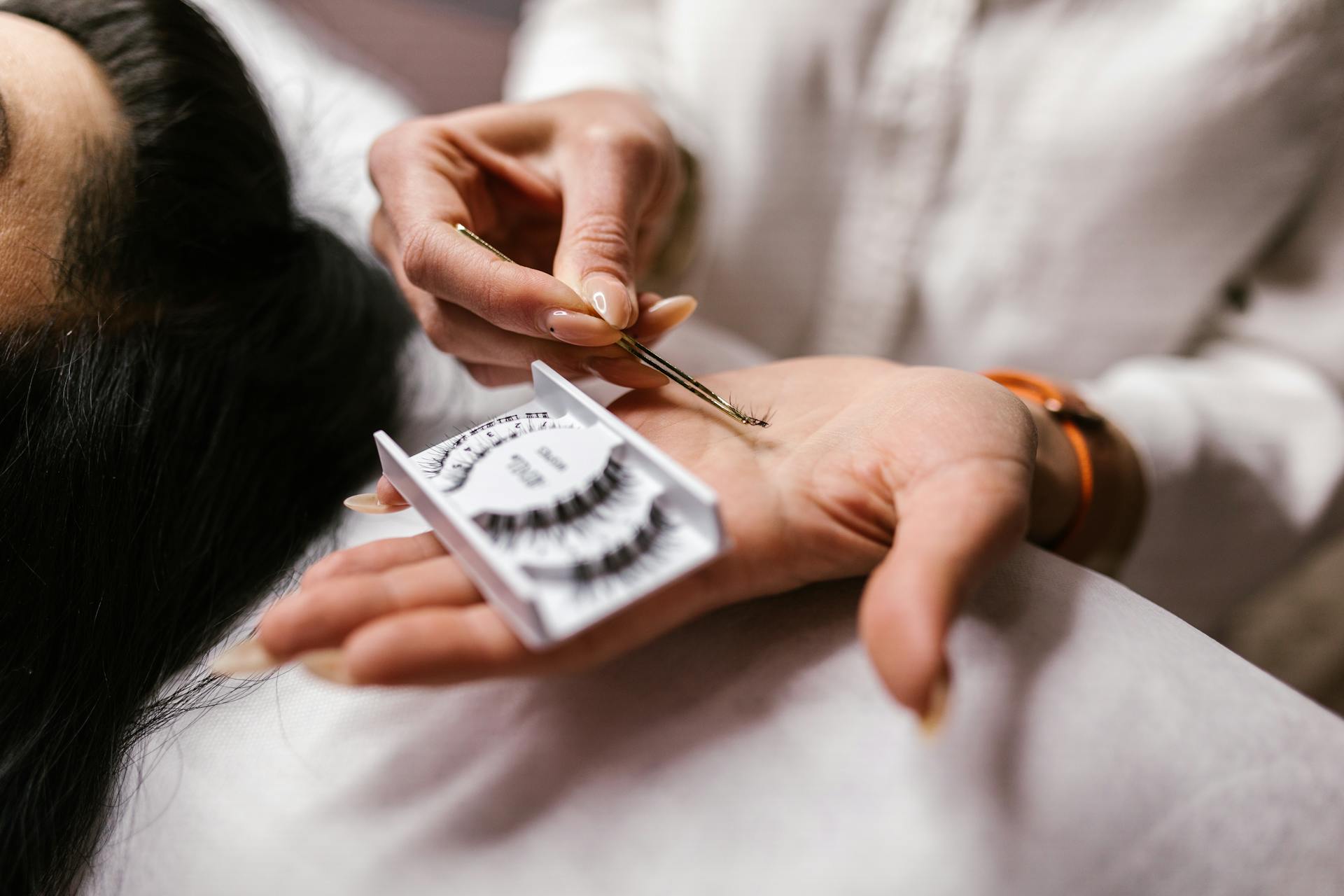 Person Holding a Set of False Eyelashes