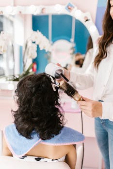 Woman receiving a hairstyle makeover in a vibrant salon setting.