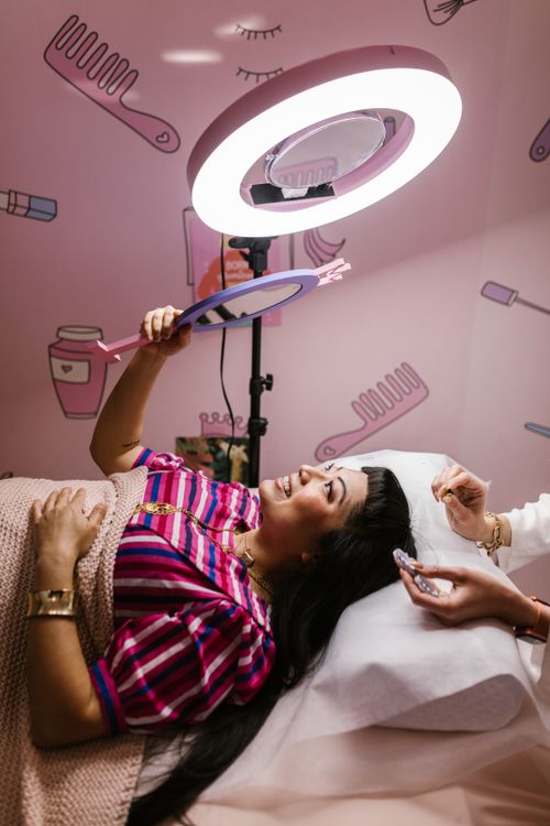 Free A woman enjoys a beauty treatment in a modern salon setting. Stock Photo
