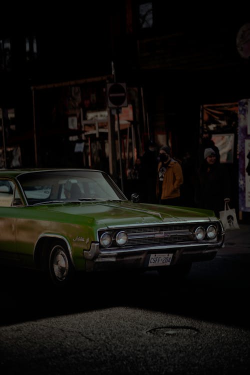 Free A Green Classic Car on the Street Road Stock Photo