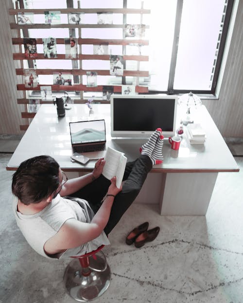 High Angle Shot of a Man Reading a Book