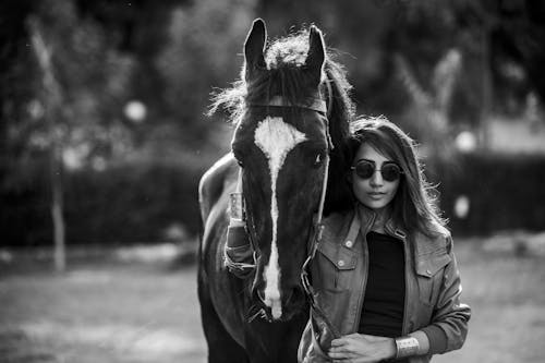 Young stylish woman with horse