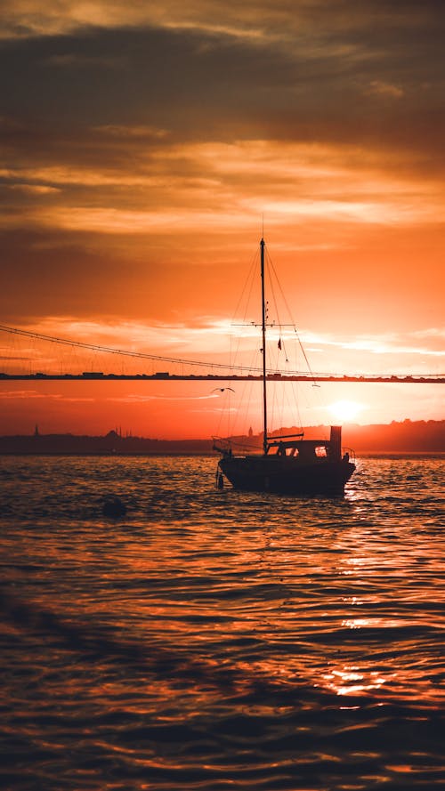 Sailing yacht floating at sunset time