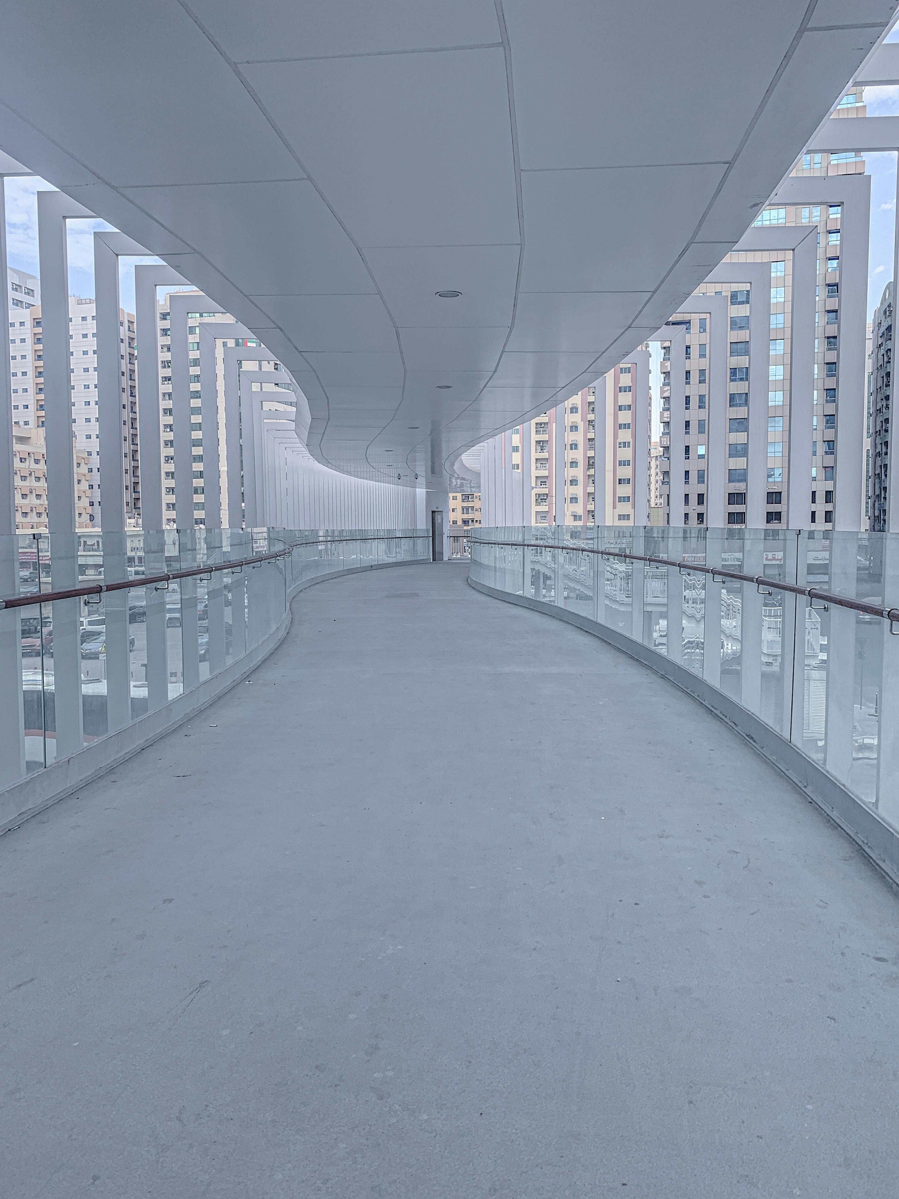 A Curved Hallway with Glass Walls · Free Stock Photo