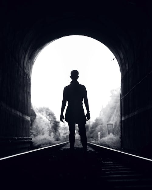 A Person Standing on the Railway Tunnel