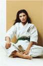 Woman Wearing a Karate Suit with Green Belt