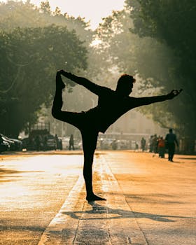 Silhouette of a person performing yoga on a Mumbai street during sunset, embodying peace and balance.