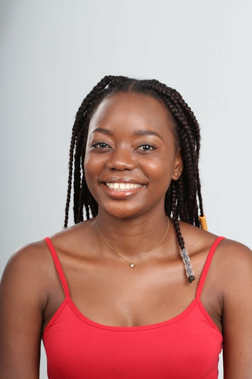 Portrait of a Woman in a Red Tank Top Smiling at the Camera