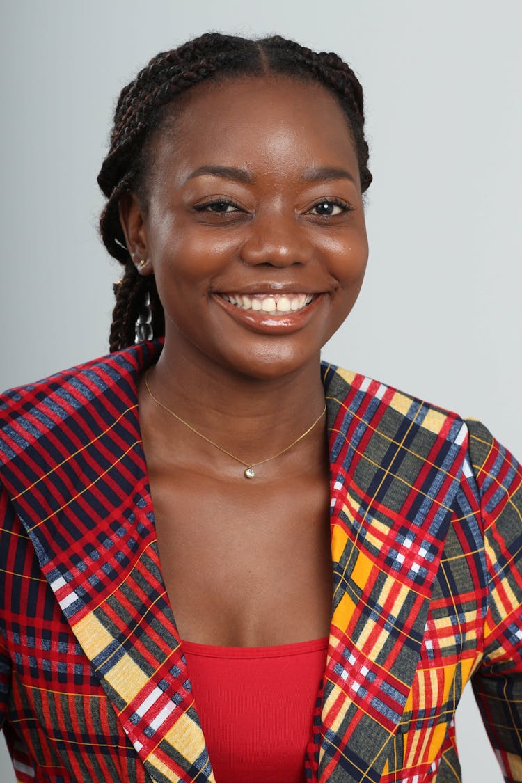 Woman In Colorful Checkered Blazer Smiling