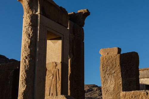 Free Explore the ancient Gate of All Nations at Persepolis, Iran, beautifully illuminated by the setting sun. Stock Photo