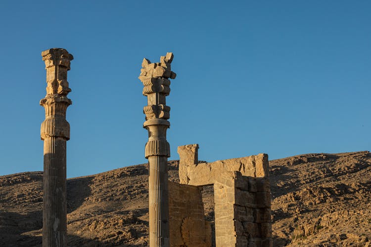 Pillars With Carvings Under A Blue Sky