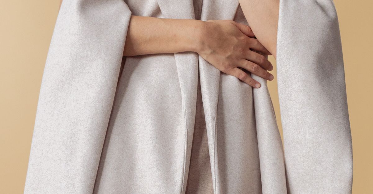 Hugging Coat A Person Hugging a Beige Coat · Free Stock Photo