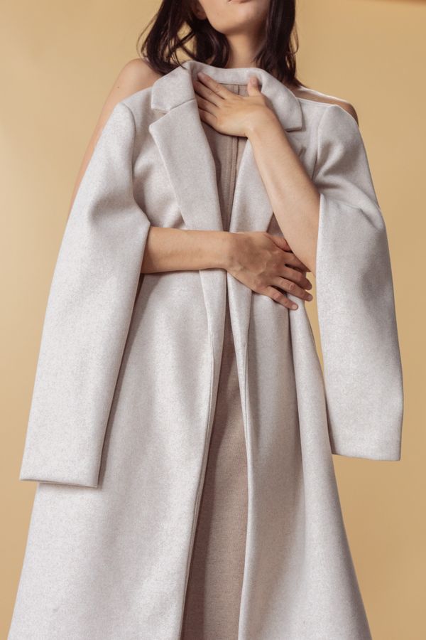 Woman in cape blazer over black dress