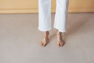Woman in White Pants and Brown Leather Sandals