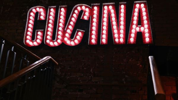 Insegna luminosa Cucina in un ristorante con pareti in mattoni
