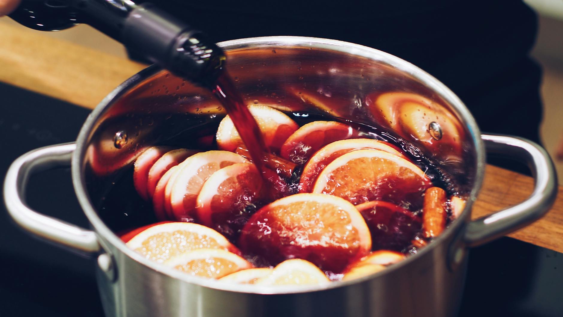 Cranberry mulled wine in a glass with spices on the side