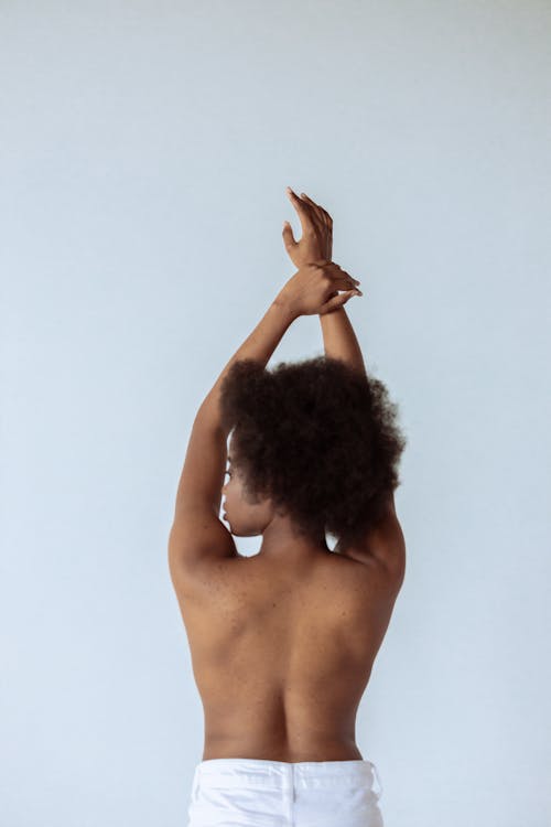 Free A Topless Woman Raising Her Hands Stock Photo