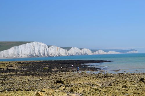 Free Explore the breathtaking white chalk cliffs of Seven Sisters, Seaford, UK, with rocky shore and scenic views. Stock Photo