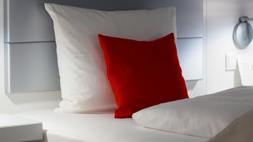 Красные и белые подушки для кровати