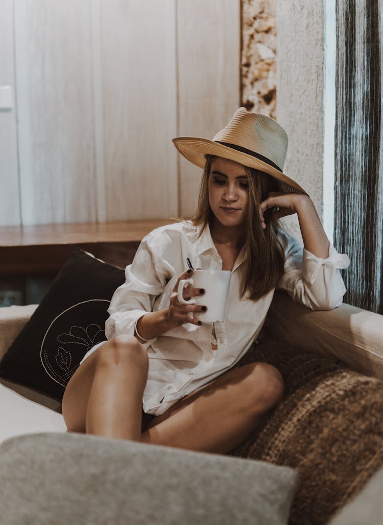 Woman With Brown Hat Holding White Mug