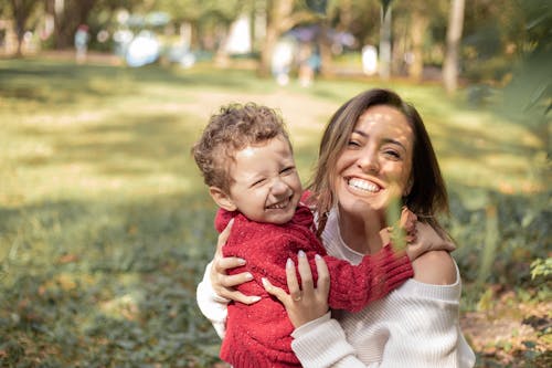 Selective Focus Photo of a Mother and Her Child Laughing Together
