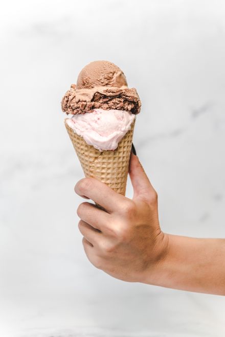 Strawberry and cocoa scoops in a waffle cone — photo by Nick Mayer on Pexels
