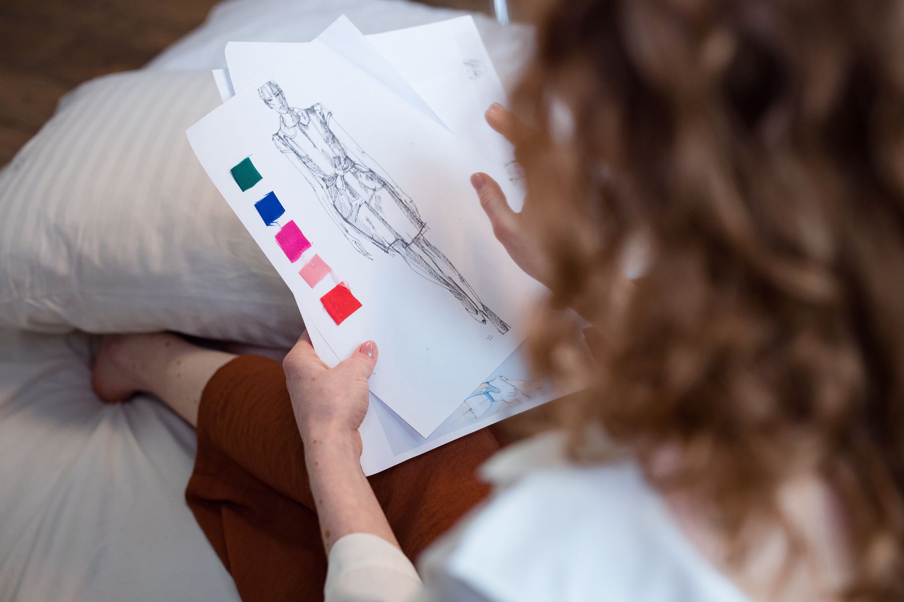 Fashion designer reviewing sketches and fabric samples