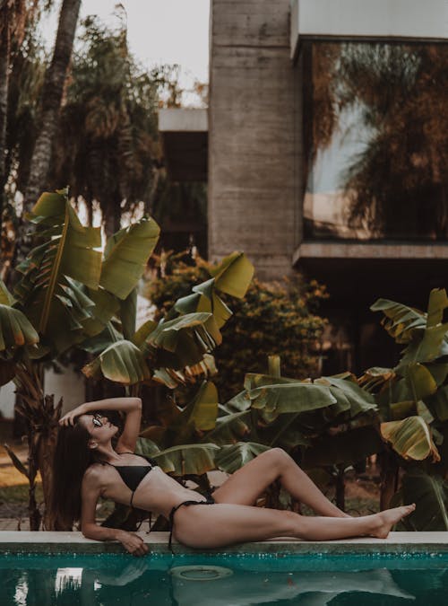 A Sexy Woman in Black Bikini Posing by the Poolside