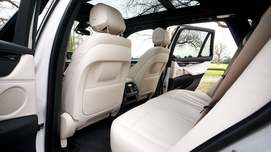 How to Install Rear-Facing Car Seats Correctly: LATCH vs Seat Belt Guide Explore the spacious and luxurious interior of a BMW SUV, featuring leather seats and a sunroof.