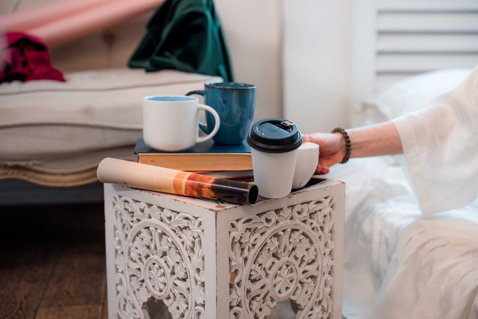 A Guide to Choosing the Perfect Compact Side Table in Jaipur for Urban Living Person using a compact side table in a Jaipur urban home with storage and modern decor