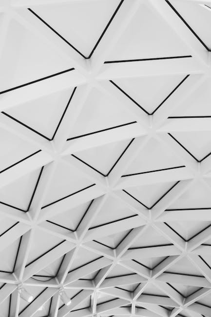 Explore the symmetry of this futuristic geometric ceiling in a striking black and white palette.