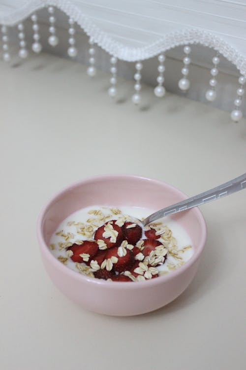 Oats and Sliced Strawberries on Ceramic Bowl