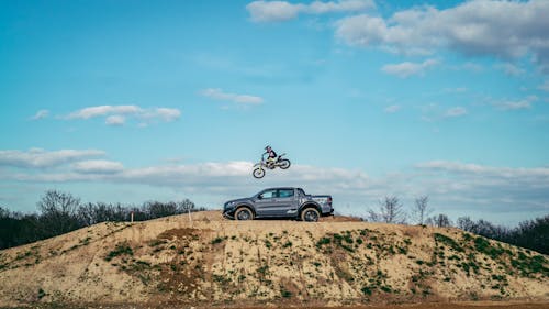 Free A Person on a Motorcycle Jumping over a Pickup Truck Stock Photo