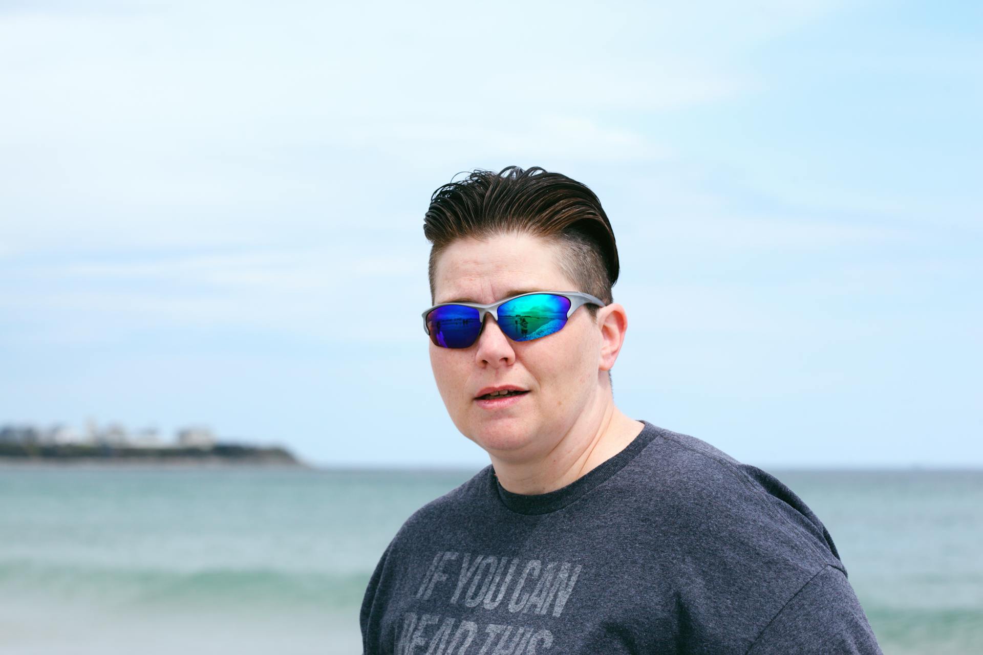 Person in sunglasses with short hair at a beach in Hampton, New Hampshire.