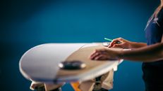 Person Holding White and Blue Plane