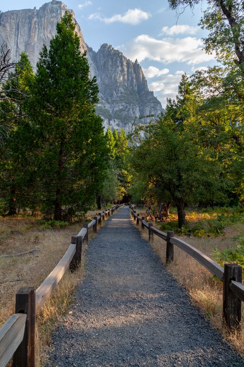 Free Dusty path with fence in a park, leading to inspiring mountain view. Stock Photo