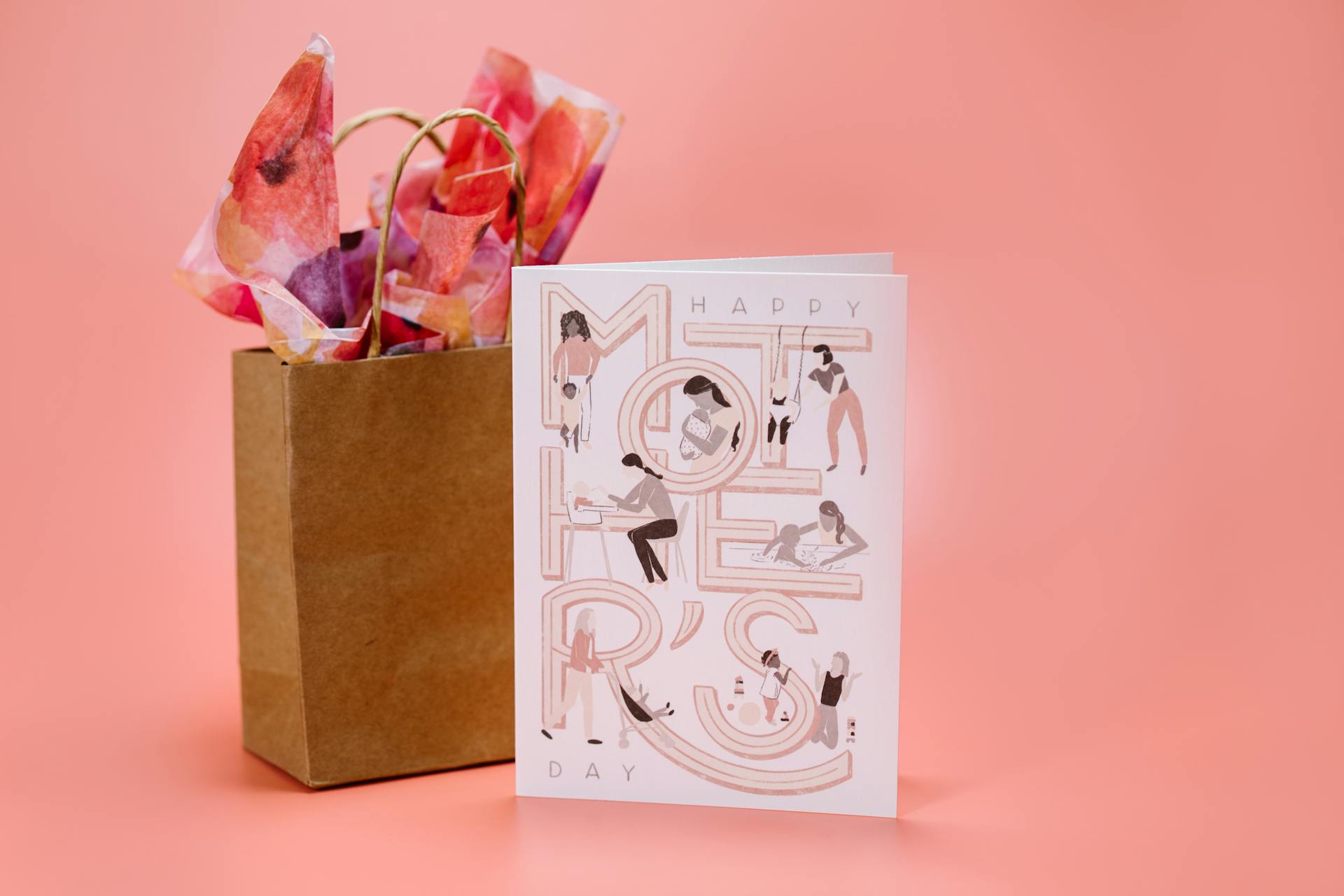 Elegant Mother's Day card with gift bag on a pink background. Perfect for celebrating mom.