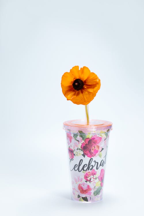 Plastic Cup with Floral Design and a Yellow Flower