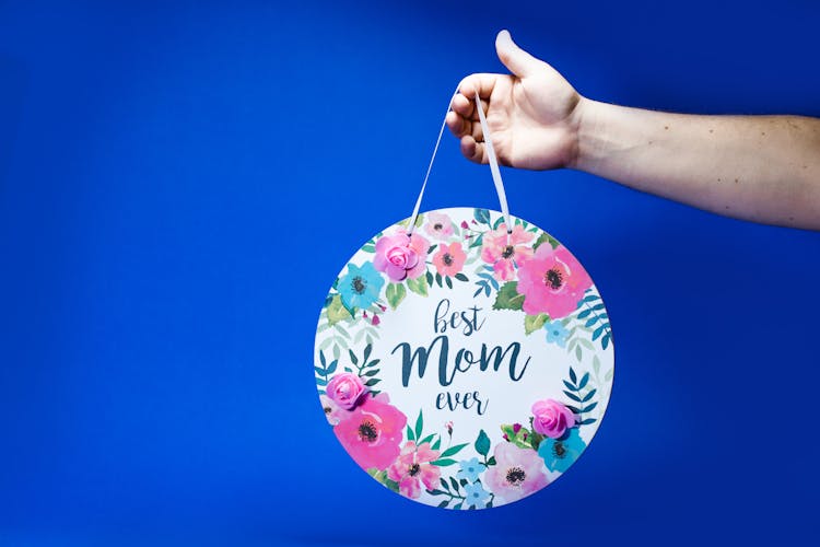 Person Holding A Floral Mother's Day Gift 