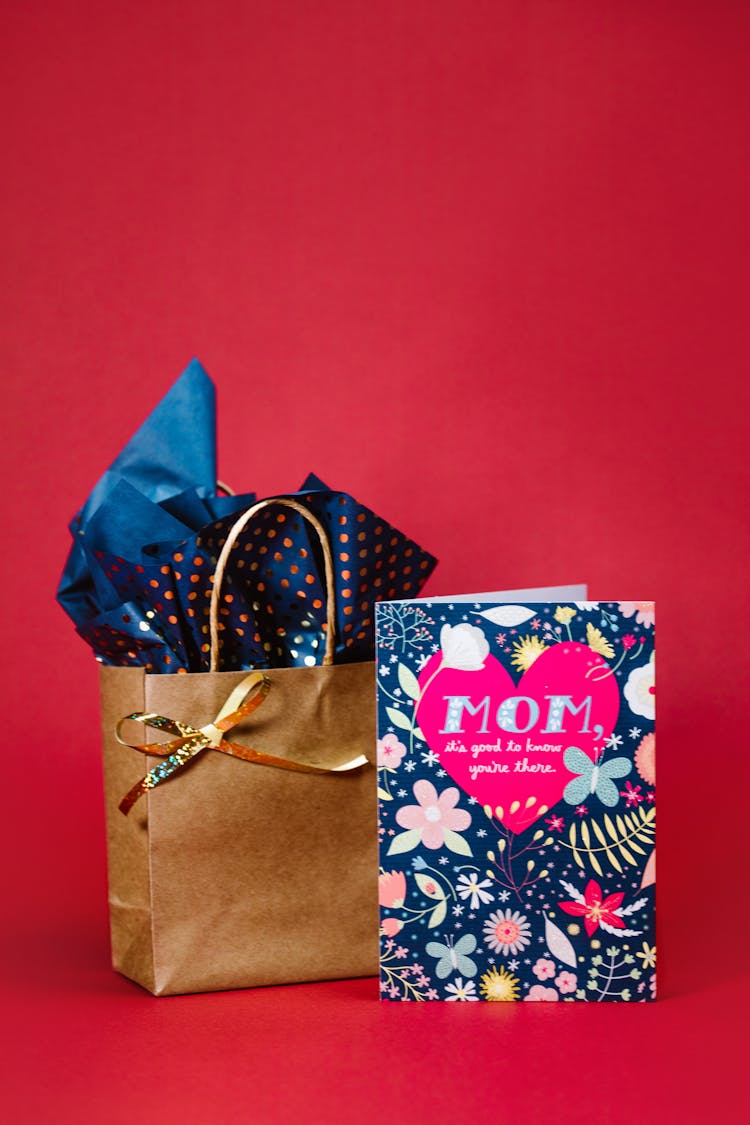 Paper Bag With Ribbon And A Greeting Card With Floral Design