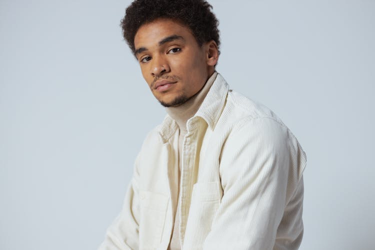 Close-Up Shot Of Handsome Man In Beige Turtle Neck Long Sleeves Looking At Camera