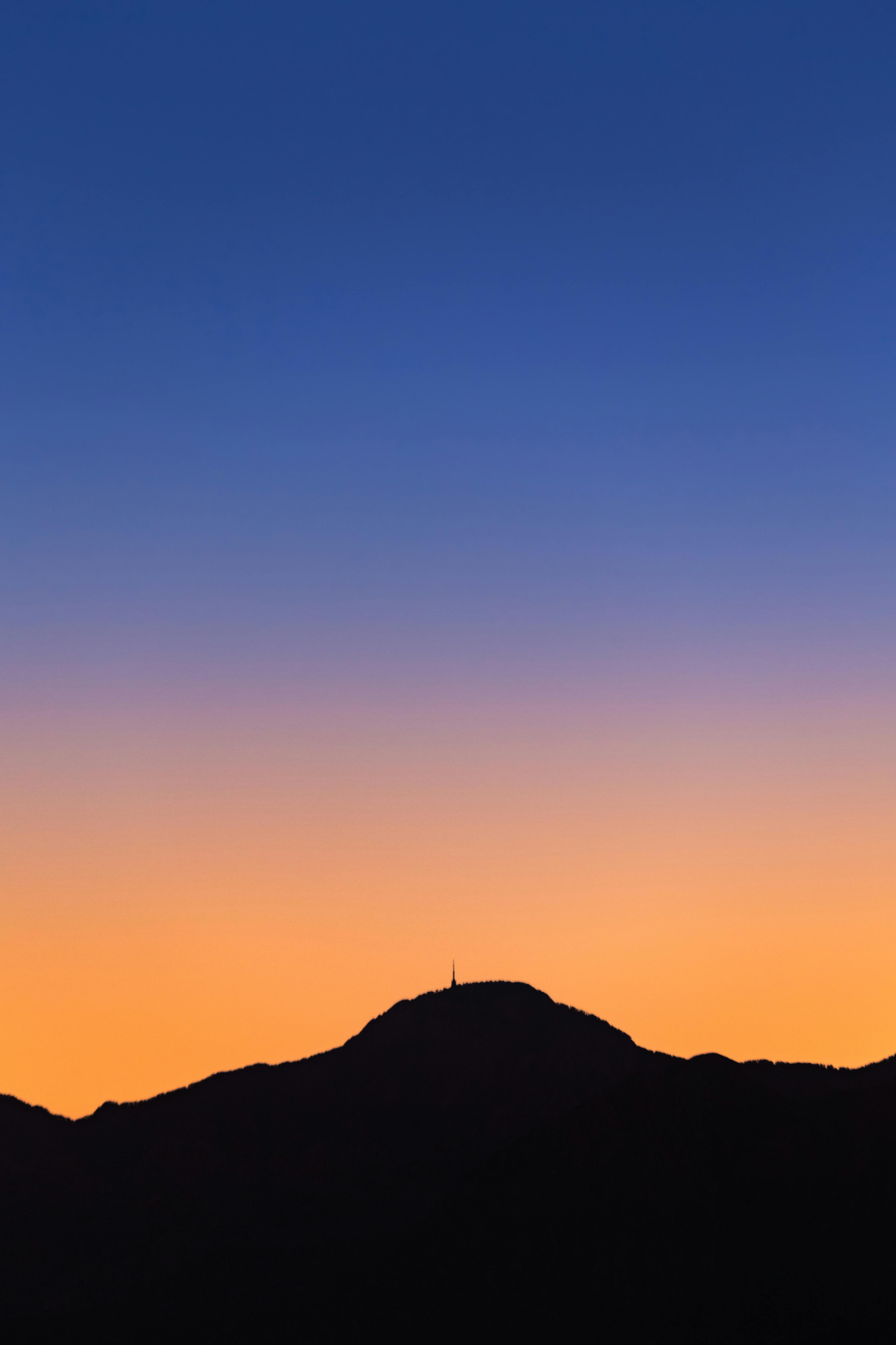 Breathtaking silhouette of mountains against a vibrant sunset sky in Antalya, Turkey.