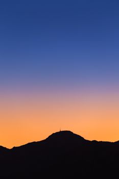 Breathtaking silhouette of mountains against a vibrant sunset sky in Antalya, Turkey.