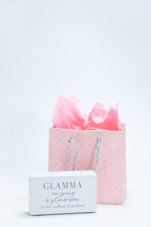 Pink Paper Bag and a Box With Printed Text