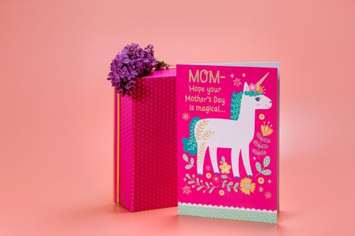 Free Colorful Mother's Day card with flowers and a unicorn design on a pink background. Stock Photo