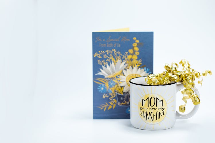 Greeting Card Beside A Mug