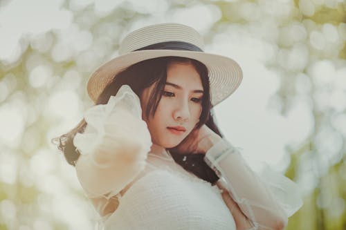 Free Woman Wears White Dress and Brown Hat Stock Photo